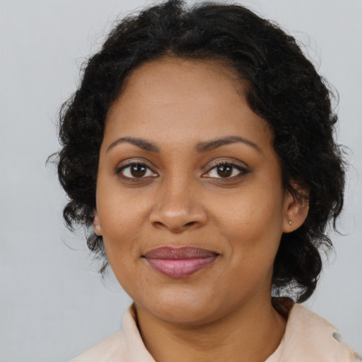 Joyful black young-adult female with medium  brown hair and brown eyes