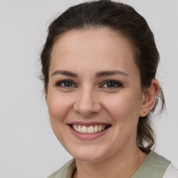 Joyful white young-adult female with medium  brown hair and brown eyes