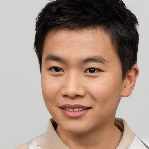 Joyful asian young-adult male with short  brown hair and brown eyes