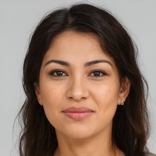 Joyful latino young-adult female with long  brown hair and brown eyes