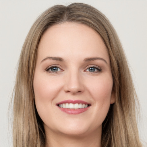 Joyful white young-adult female with long  brown hair and brown eyes