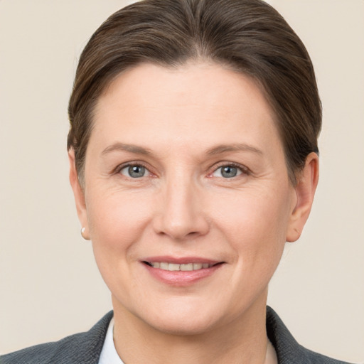 Joyful white adult female with short  brown hair and grey eyes