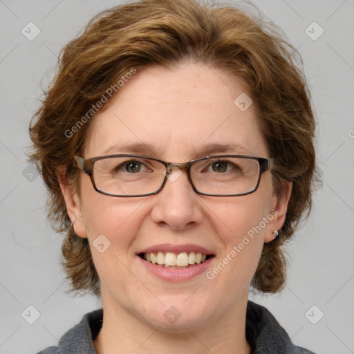 Joyful white adult female with medium  brown hair and blue eyes