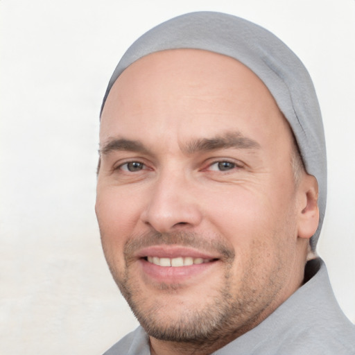 Joyful white adult male with short  black hair and brown eyes