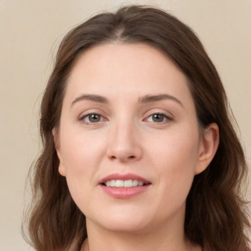 Joyful white young-adult female with long  brown hair and grey eyes