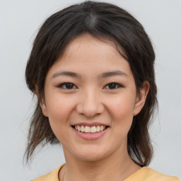 Joyful asian young-adult female with medium  brown hair and brown eyes