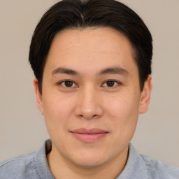 Joyful asian young-adult male with short  brown hair and brown eyes