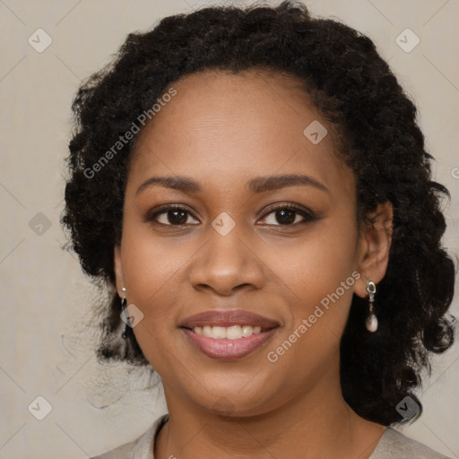 Joyful black young-adult female with long  brown hair and brown eyes