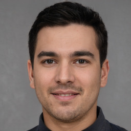 Joyful white young-adult male with short  black hair and brown eyes