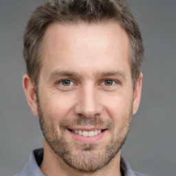 Joyful white adult male with short  brown hair and brown eyes