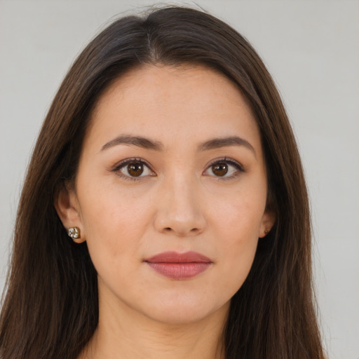 Joyful white young-adult female with long  brown hair and brown eyes