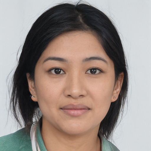 Joyful asian young-adult female with medium  black hair and brown eyes