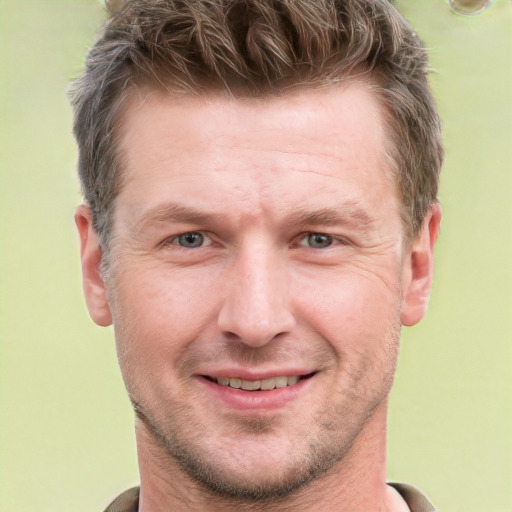 Joyful white adult male with short  brown hair and grey eyes