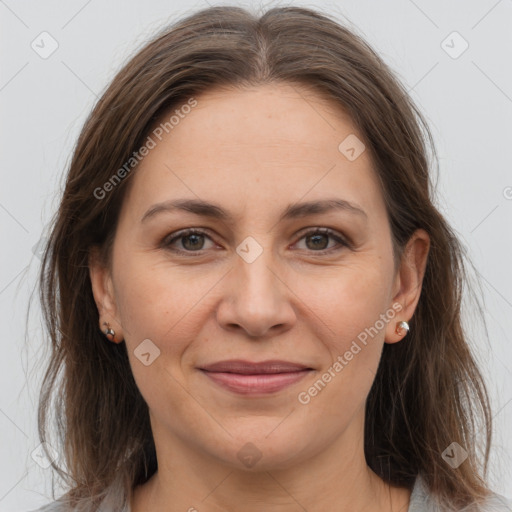 Joyful white adult female with medium  brown hair and grey eyes