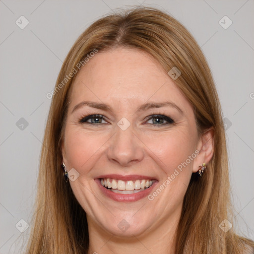 Joyful white adult female with long  brown hair and brown eyes