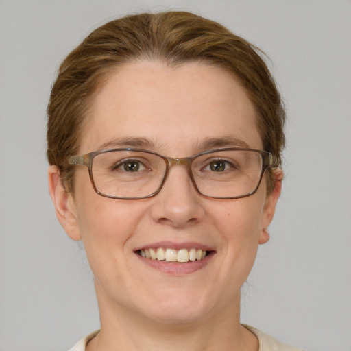 Joyful white adult female with short  brown hair and green eyes