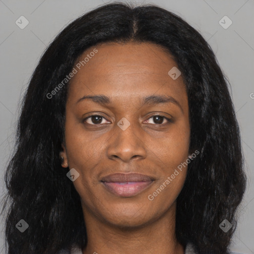 Joyful black young-adult female with long  black hair and brown eyes