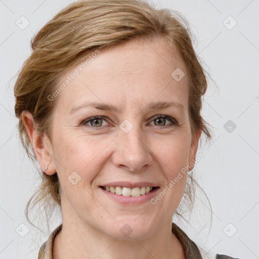 Joyful white adult female with medium  brown hair and grey eyes