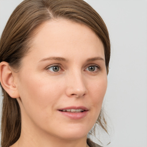 Joyful white young-adult female with medium  brown hair and grey eyes