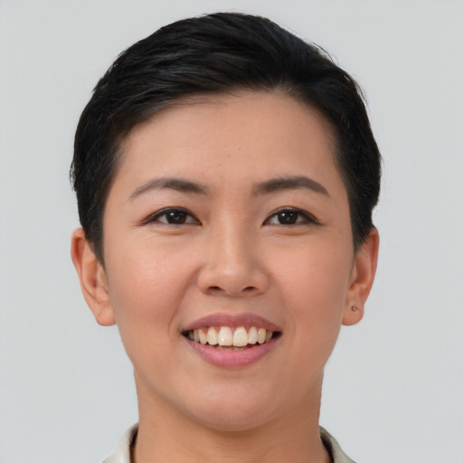 Joyful asian young-adult female with short  brown hair and brown eyes