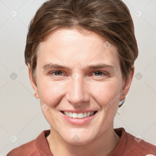 Joyful white young-adult female with short  brown hair and grey eyes