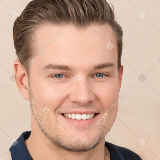 Joyful white young-adult male with short  brown hair and grey eyes