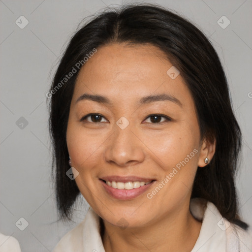 Joyful asian adult female with medium  brown hair and brown eyes