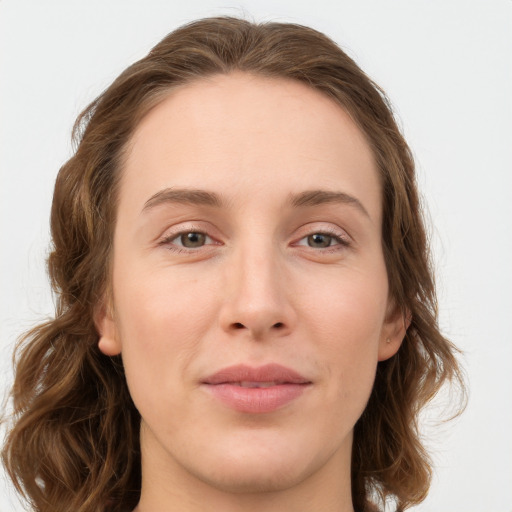 Joyful white young-adult female with long  brown hair and green eyes