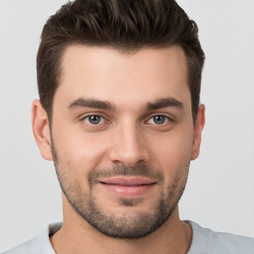 Joyful white young-adult male with short  brown hair and brown eyes