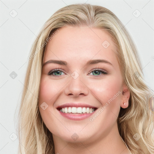 Joyful white young-adult female with long  brown hair and blue eyes