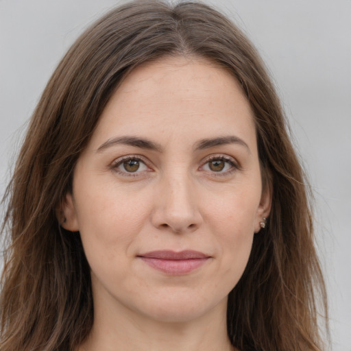 Joyful white young-adult female with long  brown hair and grey eyes