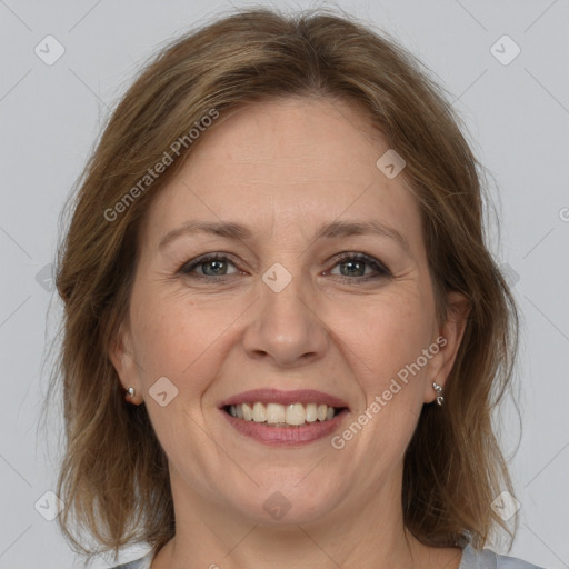 Joyful white adult female with medium  brown hair and grey eyes