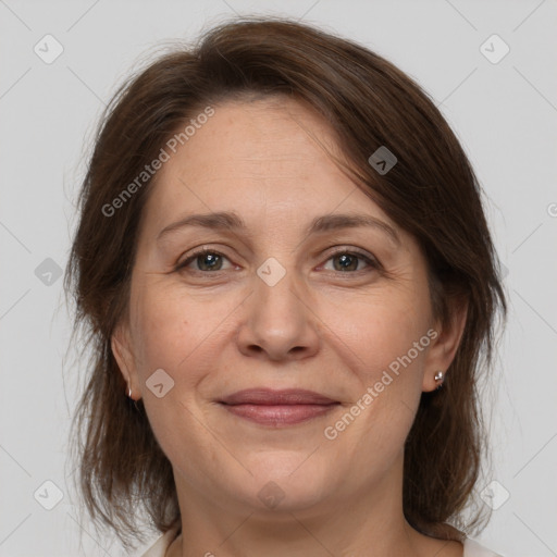 Joyful white adult female with medium  brown hair and brown eyes