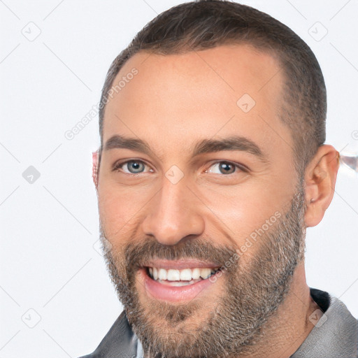 Joyful white adult male with short  brown hair and brown eyes