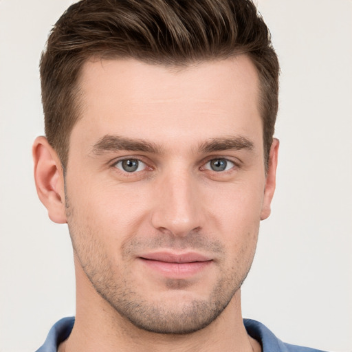 Joyful white young-adult male with short  brown hair and grey eyes