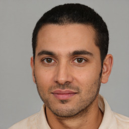 Joyful white young-adult male with short  black hair and brown eyes