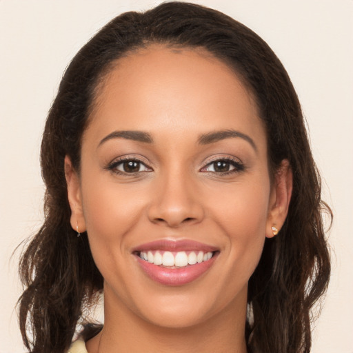 Joyful white young-adult female with long  brown hair and brown eyes