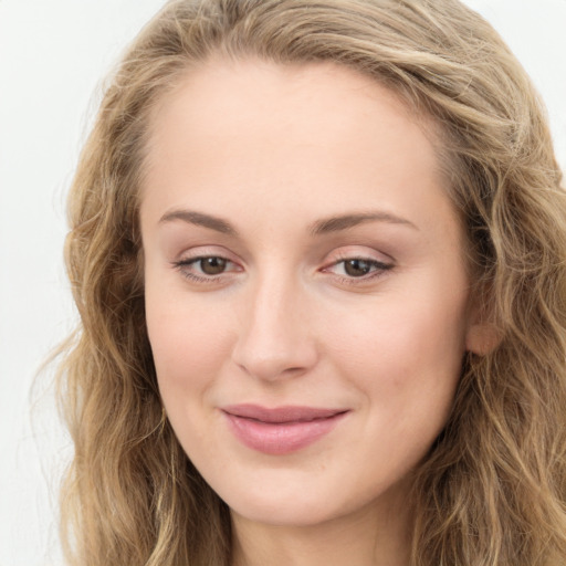 Joyful white young-adult female with long  brown hair and green eyes