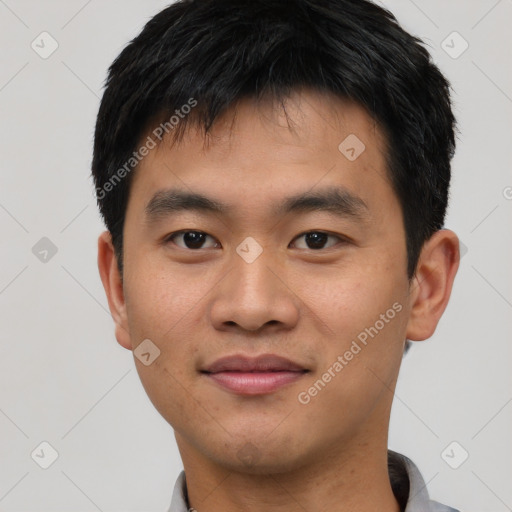 Joyful asian young-adult male with short  black hair and brown eyes