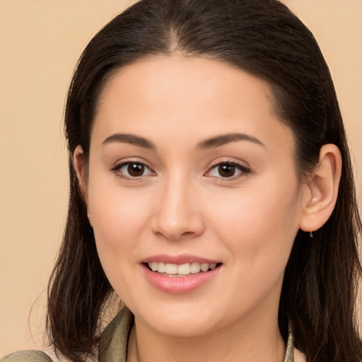 Joyful white young-adult female with long  brown hair and brown eyes