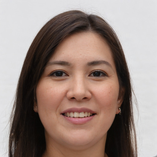 Joyful white young-adult female with long  brown hair and brown eyes