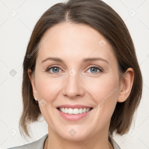 Joyful white young-adult female with medium  brown hair and grey eyes