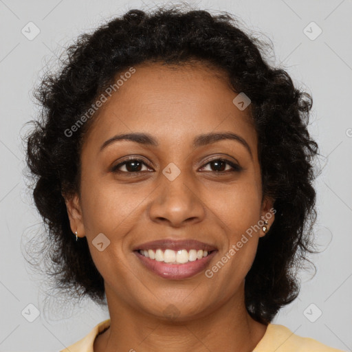 Joyful black young-adult female with long  brown hair and brown eyes