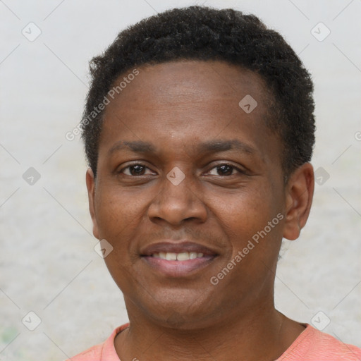 Joyful black adult male with short  brown hair and brown eyes