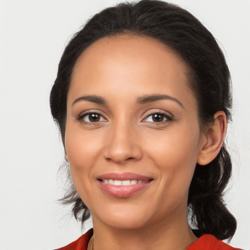 Joyful latino young-adult female with medium  brown hair and brown eyes