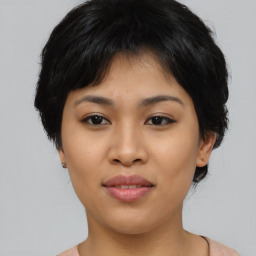 Joyful asian young-adult female with medium  black hair and brown eyes