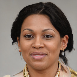 Joyful latino adult female with medium  brown hair and brown eyes