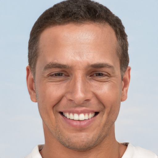 Joyful white adult male with short  brown hair and brown eyes