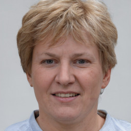 Joyful white adult female with short  brown hair and grey eyes