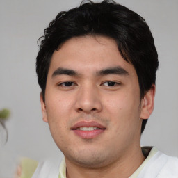 Joyful asian young-adult male with short  black hair and brown eyes